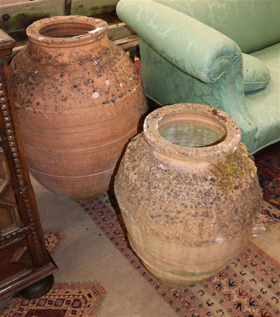 Two earthenware oil jars, largest H.76cm